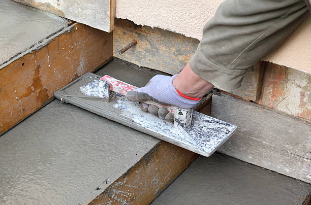 Staircase making at construction site Staircase making, worker finishing concrete with trowel, home renovation concrete in formwork stock pictures, royalty-free photos & images
