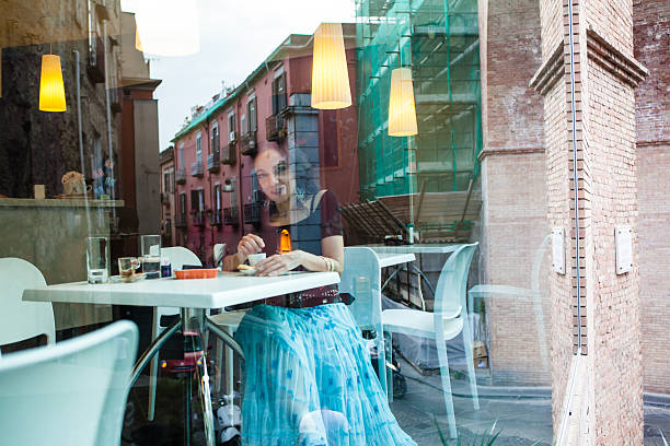 Woman Sitting at Cafe Table, drinking an italian Espresso coffee, Italy.