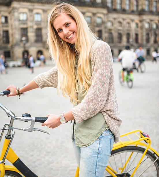 istock Dutch woman with bicycle in amsterdam dam square 535220663
