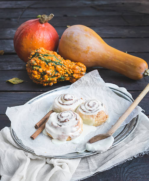 istock Cinnamon pumpkin buns with creamy cheese icing and ripe pumpkins 535223119
