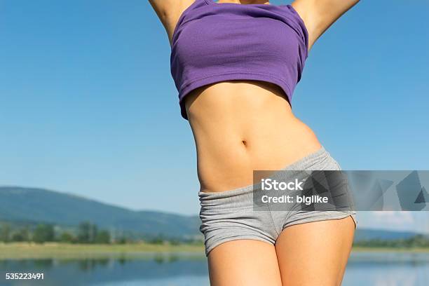 Young Fit Womans Belly Outdoors In Summer Stock Photo - Download Image Now - Women, Slim, Teenage Girls