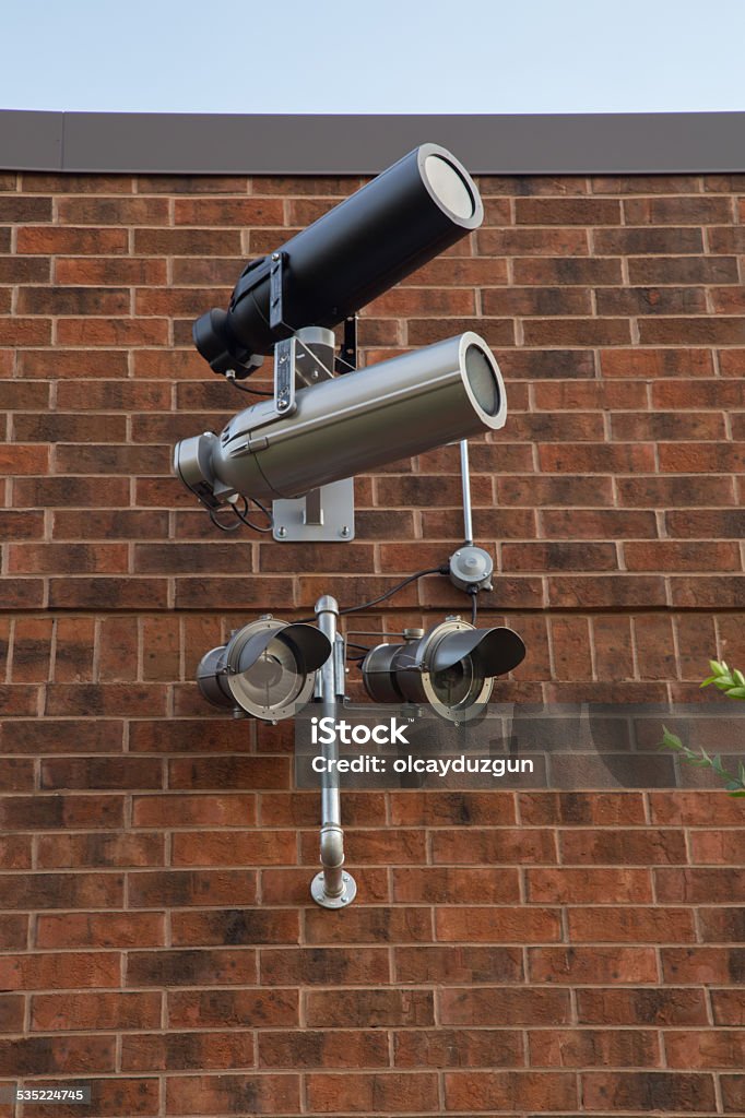 Surveillance camera on brick wall Surveillance camera 1984 Stock Photo