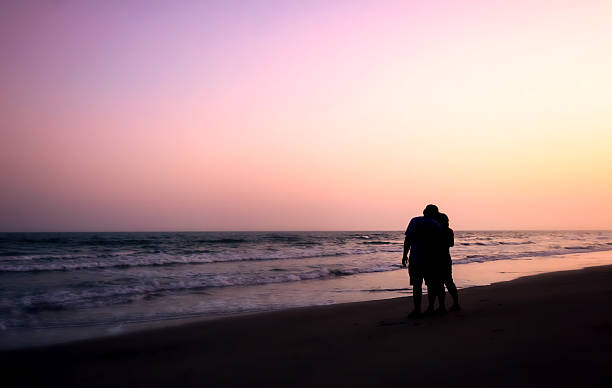 istock silhouette of couples hugging on the beach 535225827