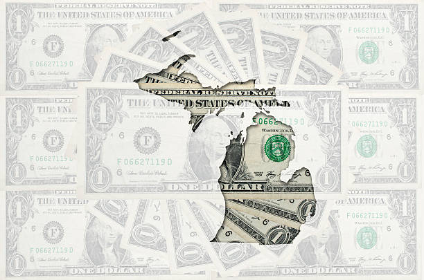 Outline map of michigan with transparent american dollar banknotes stock photo