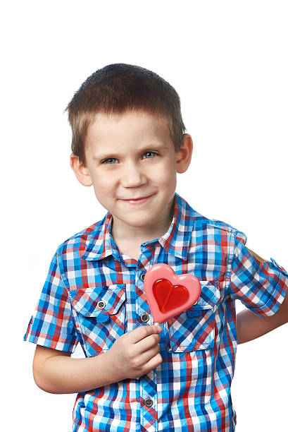 istock Funny boy with lollipop hearts 535227919