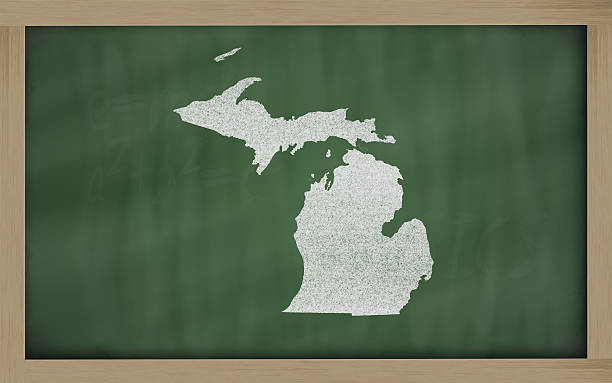 outline map of michigan on blackboard stock photo