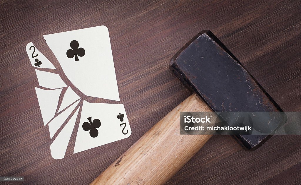 Hammer with a broken card, two of clubs Hammer with a broken card, vintage look, two of clubs 2015 Stock Photo