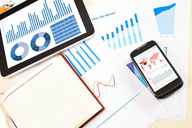 istock digital tablet and smartphone with financial chart report, paper 535239549