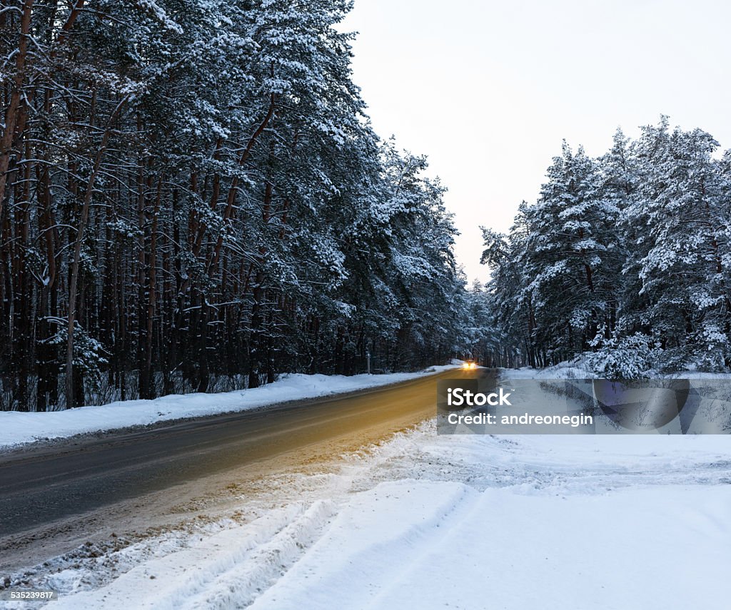 road in a snowy forest road in a snowy forest with car 2015 Stock Photo