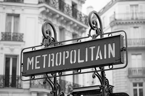 Paris, France Metropolitain or Metro Station Subway Sign Paris, France Metro Station Subway Sign.  The metro line in Paris is one of the world's oldest subway or underground transportation systems.  Here, the Metro is spelled out fully as Metropolitain.  Later, it was shortened to Metro.  In the background old architecture and buildings can be seen, as urban scenes of Paris. paris metro sign stock pictures, royalty-free photos & images