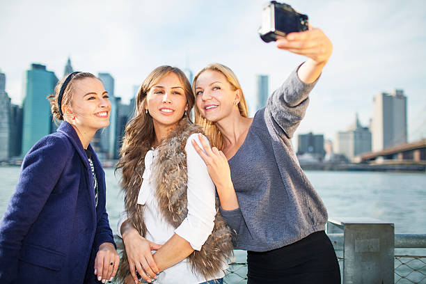 istock Three happy girlfriends taking selfie in New York City 535240425