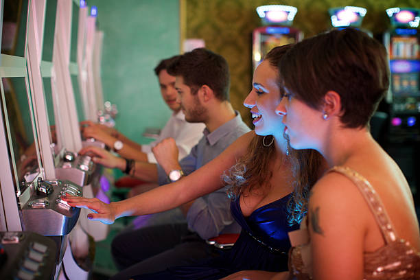 istock Friends gambling on slot machines 535245557