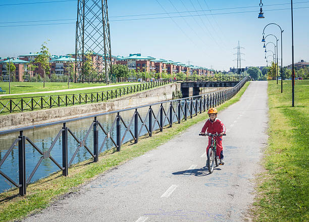 Little Boy Cycling On Line Near Canal stock photo