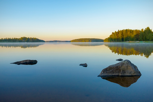 Beautiful lake at sunset in Sweden\ncalm water in pastel