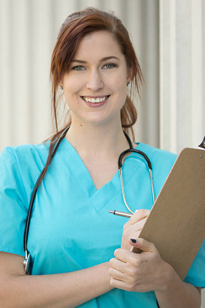 istock Smiling Nurse Holding Clipboard 535262363