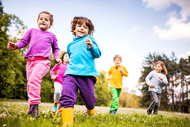 istock Group of children running in nature. 535264333