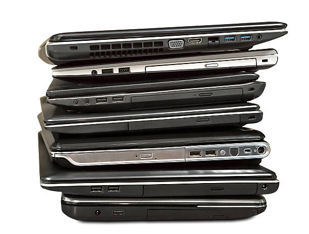 istock stack of old laptops awaiting repair isolated on white backgroun 535265121