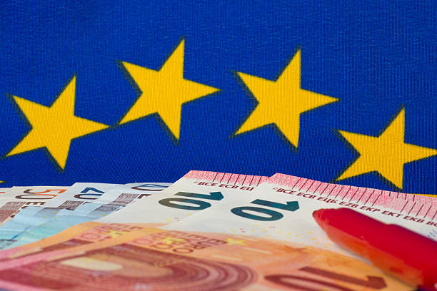 istock Euro notes and red pencil, EU flag 535266277