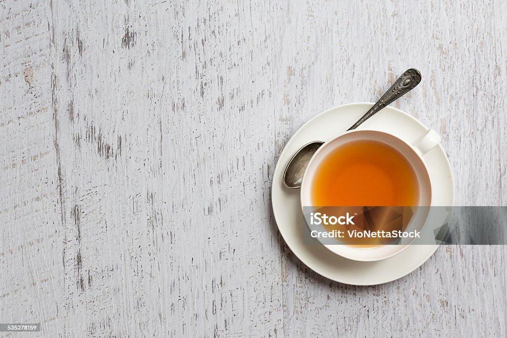 Cup of tea on white background, top view point White china cup of tea on vintage white wooden background Tea - Hot Drink Stock Photo