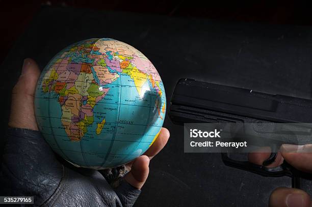Terrorist Put A Gun To Globe Stock Photo - Download Image Now - 2015, Bullet, Burglar