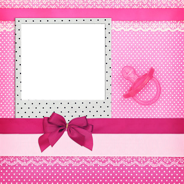 istock Photo frame and pink pacifier on polka dots background 535281023