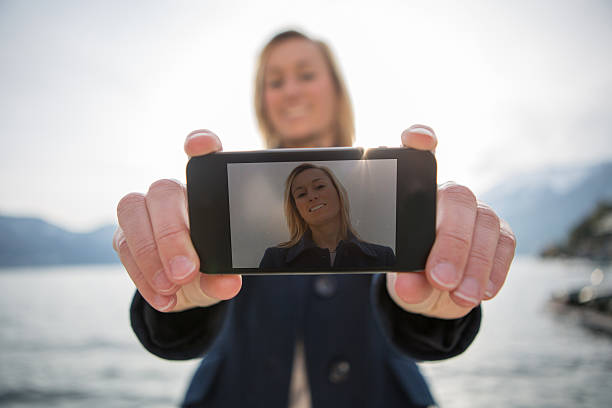istock Young woman taing a selfie using smart phone 535281705