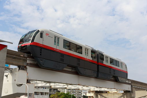 Naha, Japan - January 29, 2015 : Okinawa Monorail move past the Makishi Station in Naha, Okinawa, Japan. It is the only public rail system in Okinawa Prefecture.