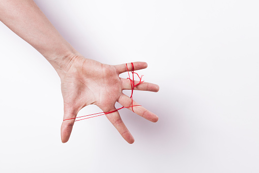 Woman hand palm with red string