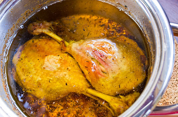Traditional slow cooked duck confit in the pot stock photo