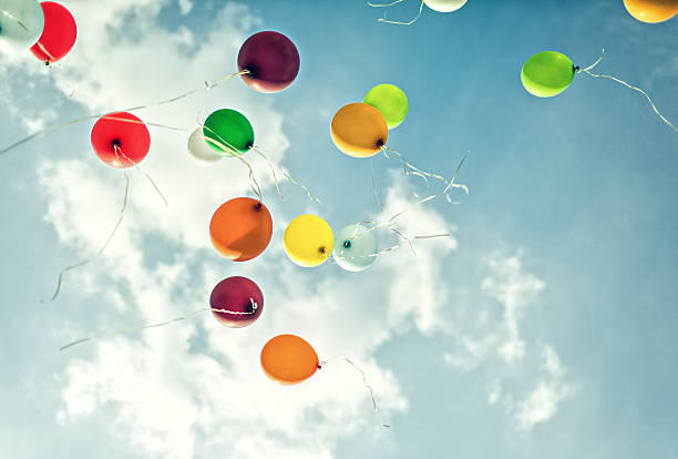 Flying Balloons Flying Color Balloons in the Sky releasing stock pictures, royalty-free photos & images