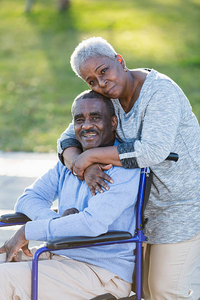 senior coppia afro-americana, uomo in sedia a rotelle - couple dependency standing men foto e immagini stock