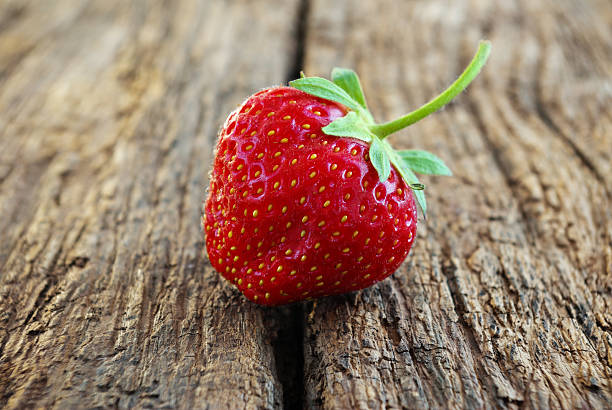 istock Ripe red strawberries on a wooden background. 535299739