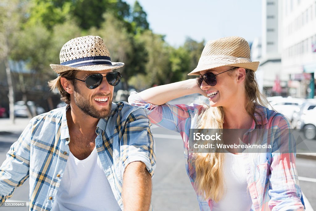 Attractive happy couple wearing sunglasses Attractive happy couple wearing sunglasses on a sunny day in the city 20-24 Years Stock Photo