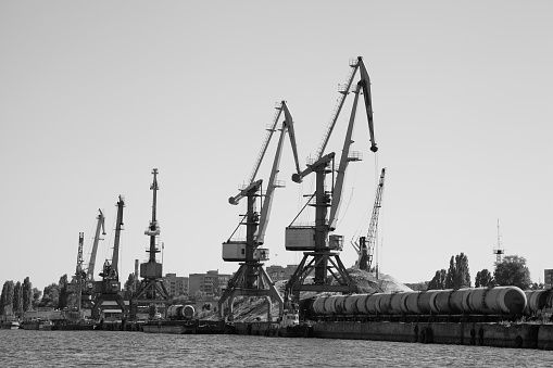 Monochrome picture of the river port and harbor cranes