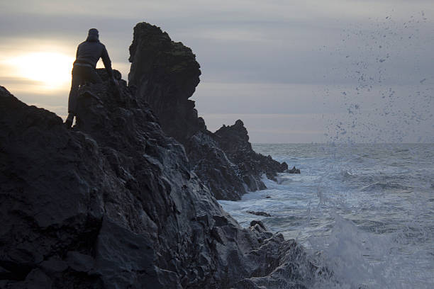 istock Man balances precariously at surf edge 535315285