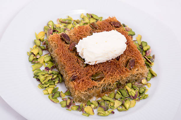 kadayif dessert with milk cream and pistachio stock photo
