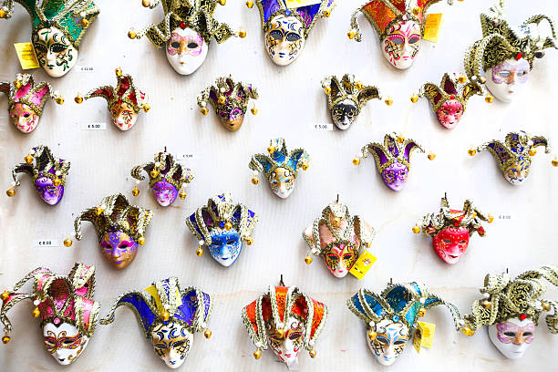 Venice, Italy - February 15th, 2014 : Colorful souvenir carnival masks with magnets displayed for sale on stand in Venice, Italy.
