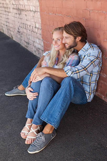 istock Cute couple sitting on ground 535317307