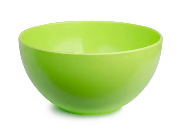 Empty green plastic bowl isolated on white