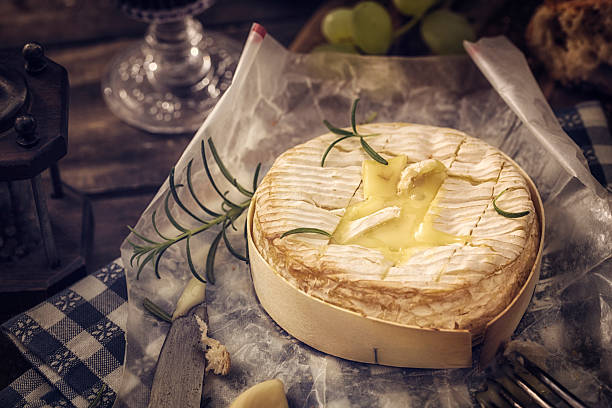 Baked Camembert Cheese Baked camembert cheese with garlic and rosemary brie stock pictures, royalty-free photos & images