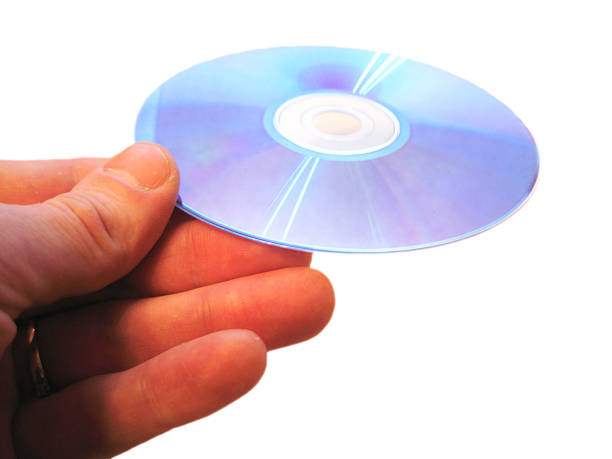 istock Mans hand holding compact disc on the finger isolated 535334089