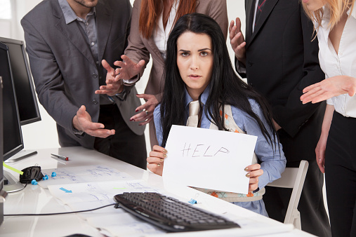 Businesswoman being bullied by his colegues.