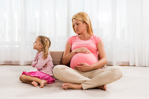 Little girl is not happy about her mother's pregnancy.