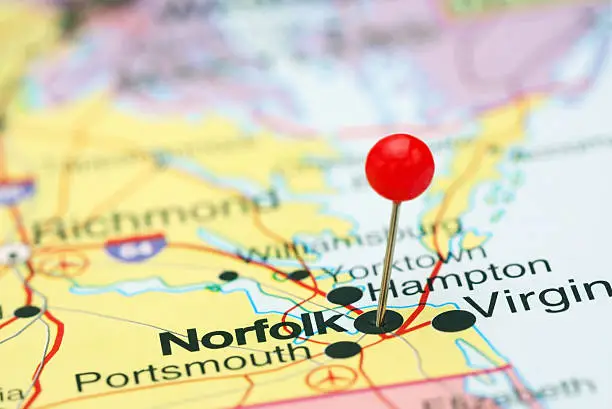 Photo of pinned Norfolk on a map of USA. May be used as illustration for travelling theme.
