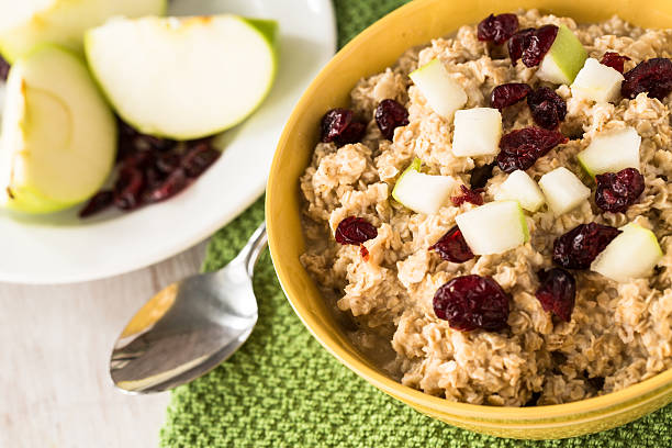 Oatmeal In A Bowl With Apples And Cranberries stock photo