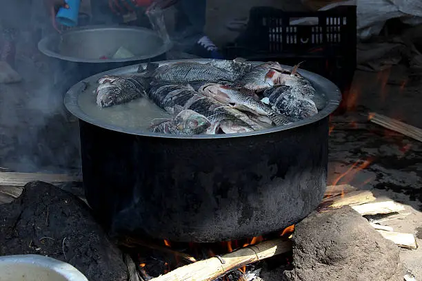 The fish market at Awassa lake, Ethiopia. Preparation of the fish-soup in caldron.