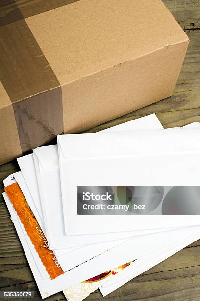 Pile Of Letters And Postal Parcel Stock Photo - Download Image Now - Mail, Table, Envelope