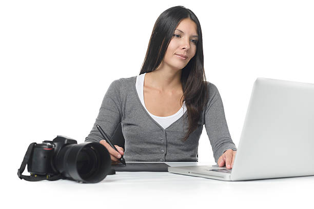 Female photographer smiling as she does her edits