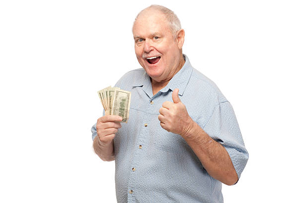 Senior man holding dollars and showing thumbs up