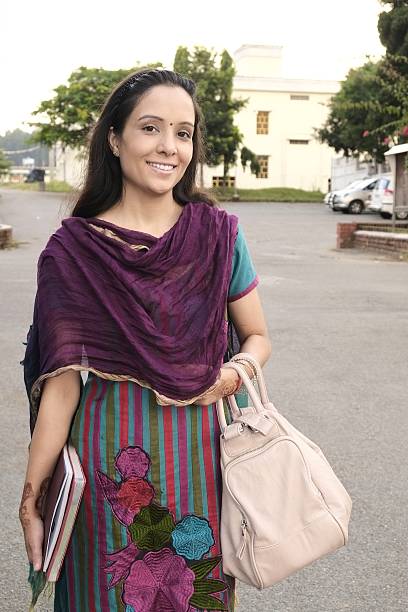 istock Attractive Indian female teacher walking on road. 535372075